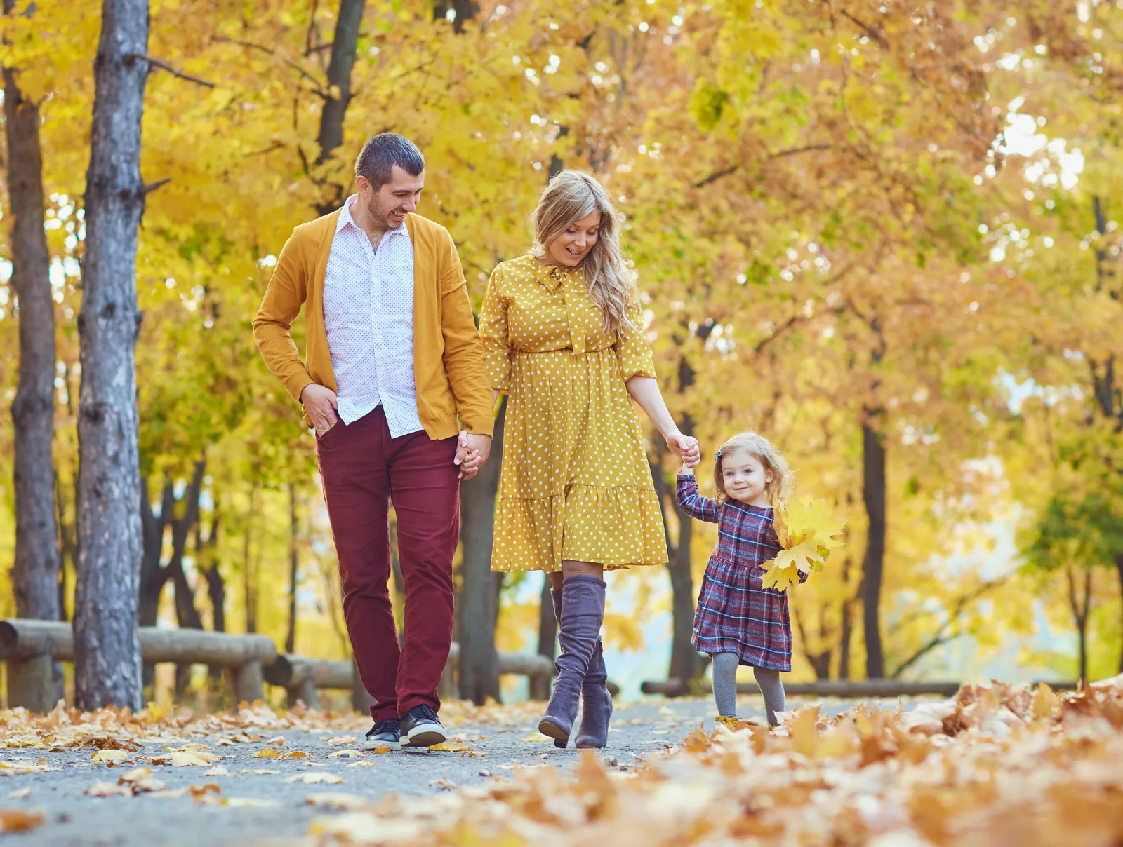 A family walking comfortably together through an autumn park, free from foot pain